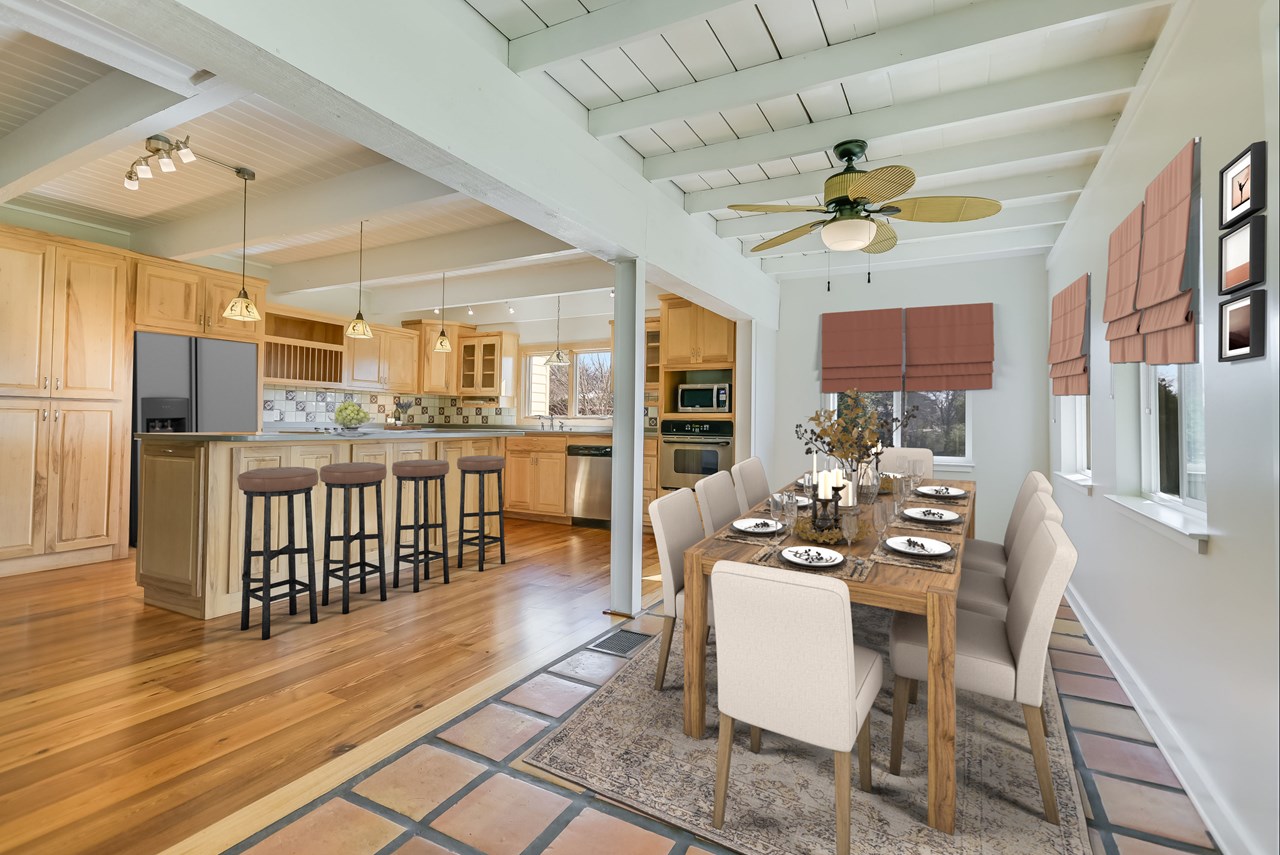 large dining area open to gourmet kitchen with walls of windows