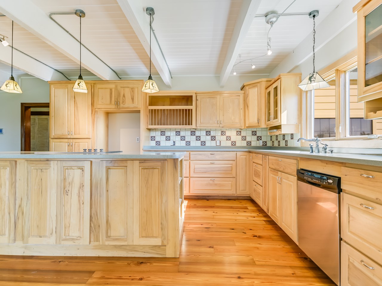 recent gourmet kitchen with hickory and pecan cabinets, corian counters, & commercial grade applainces