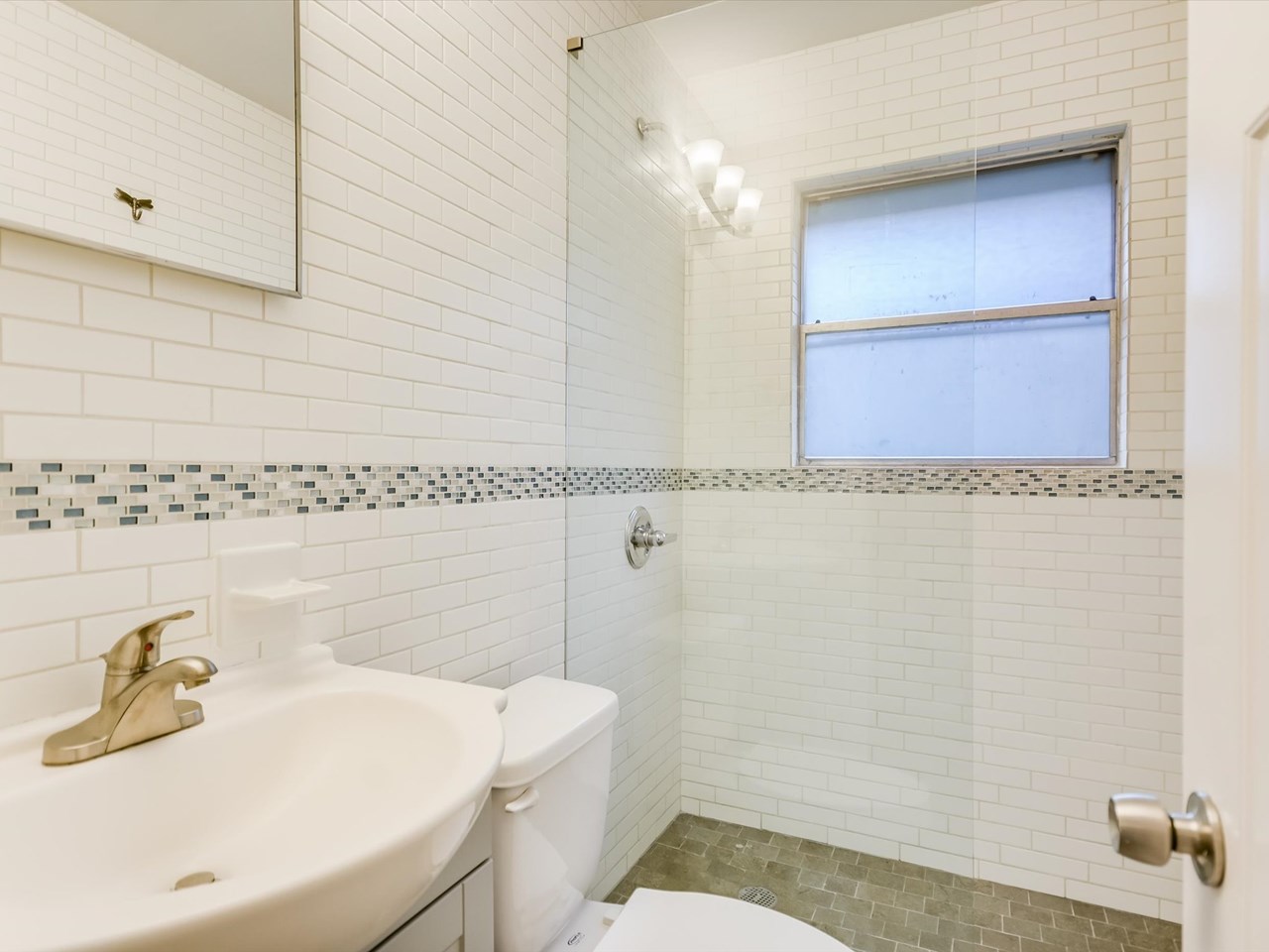 stunning redesign recent bathroom with unique floating glass partician unit a: unbelievable redesigned bathroom with floating glass panel, stone accents and period subway tile plus great storage.