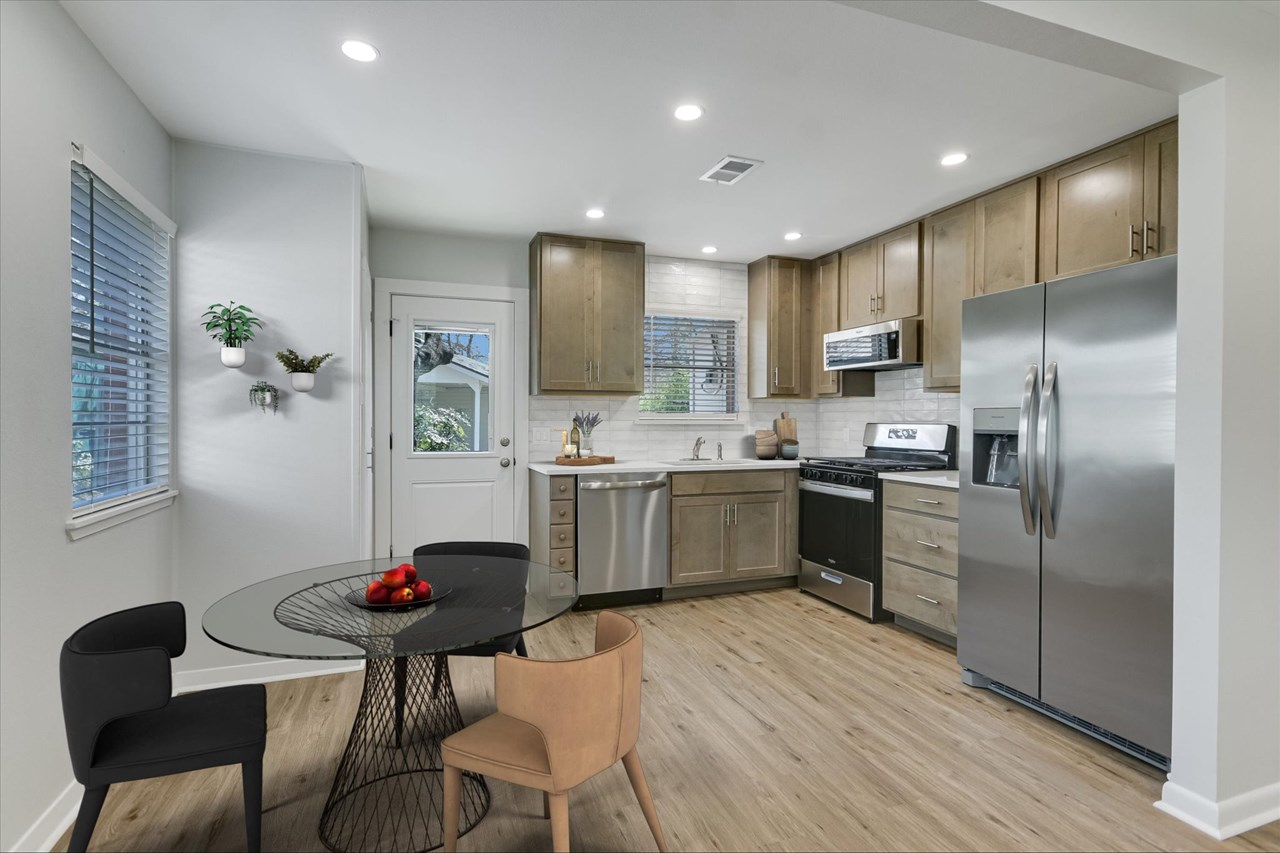 new gourmet eat-in kitchen open to central living area stunning gourmet kitchen with custom quartz counters, solid wood 42 cabinets, deep pot and spice drawers, top tier stainless steel appliance package, beautiful brick accents, large walk-in pantry, new recessed lighting and peaceful private views with great natural light.