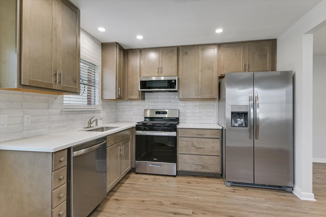exquisite new! gourmet kitchen with walk-in closet  stunning gourmet kitchen with custom quartz counters, solid wood 42 cabinets, deep pot and spice drawers, top tier stainless steel appliance package, beautiful brick accents, large walk-in pantry, new recessed lighting and peaceful private views with great natural light.
